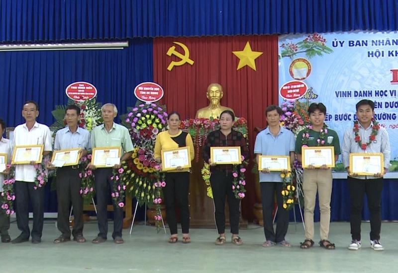 cha mẹ đại diện học sinh cùng các em học sinh lên nhận giấy khen và quà